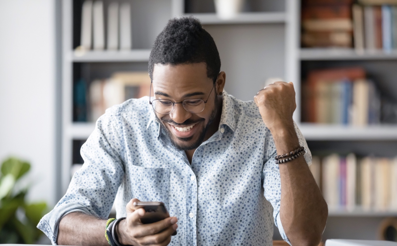 Man with Phone Celebrating