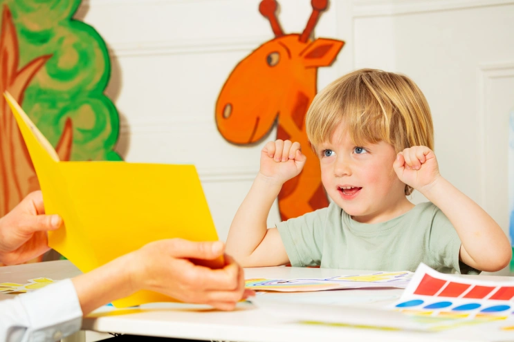 Child engaging in ABA therapy activities with colorful materials to build communication and social skills.