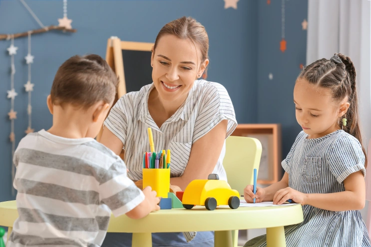 ABA therapy jobs at Mindful Sprouts supporting children during a guided learning activity at a therapy table.