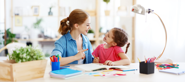 RBT career path: registered behavior technician working one-on-one with a child on communication and learning activities at a table.