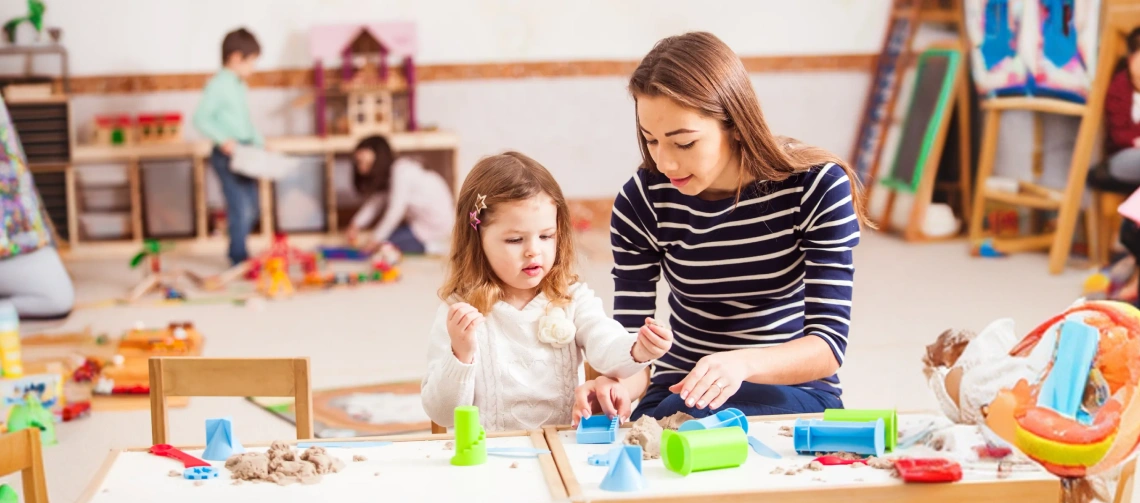 RBT supervision requirements guide showing an ABA professional supporting a child during a play-based therapy activity.