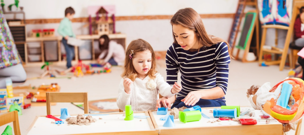 RBT supervision requirements guide showing an ABA professional supporting a child during a play-based therapy activity.